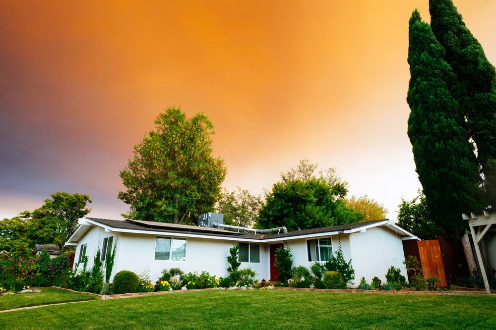 Single-story home exterior with fresh landscaping at sunset