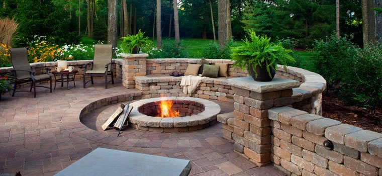 Stone patio with built-in seating and fire pit